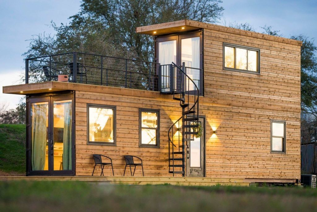 Stacked container home with a 40' container on the bottom and a 20' container on top and 20' long deck space with railing on the roof