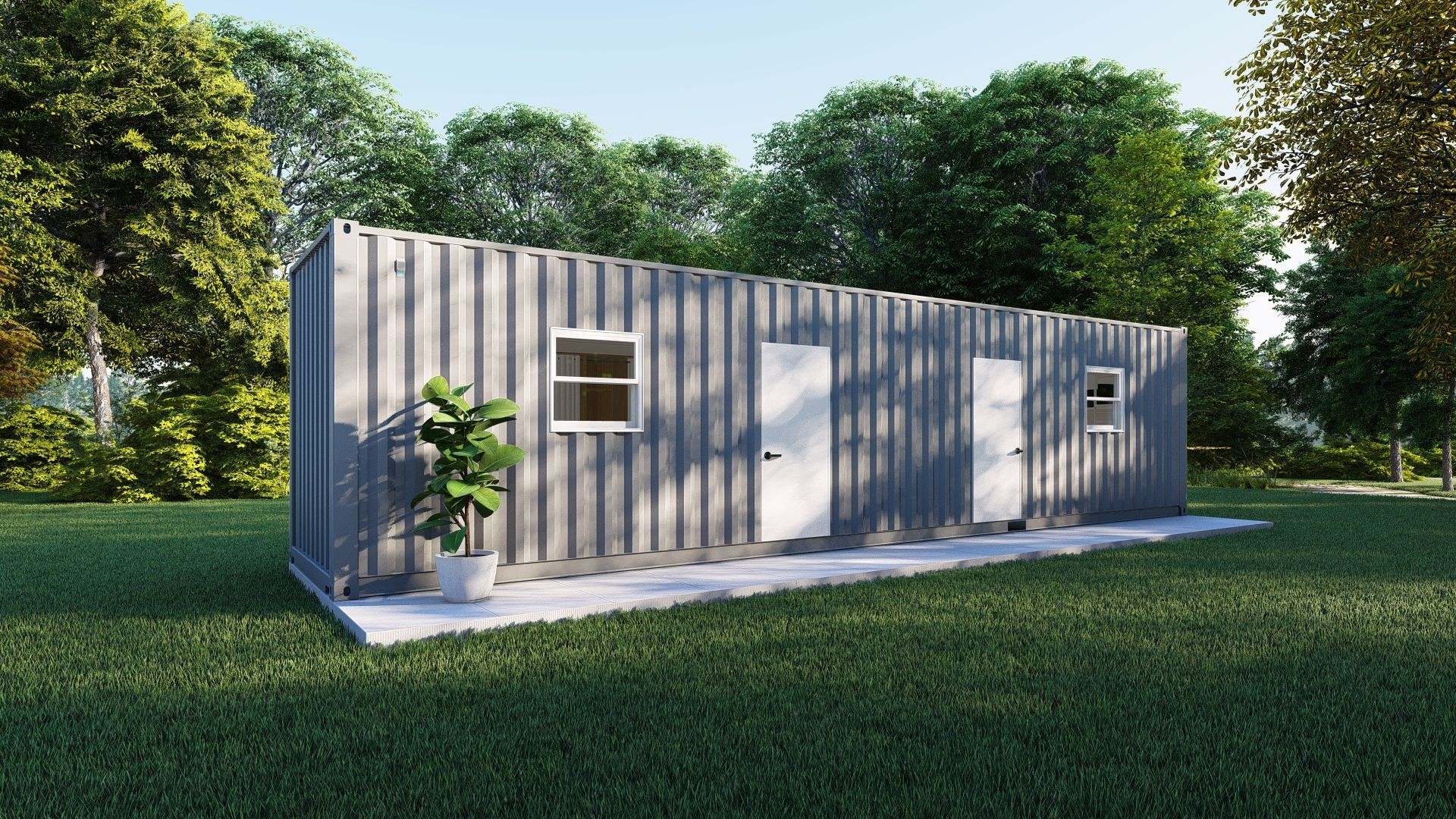 Shipping container house with windows and doors in a grassy area surrounded by trees.