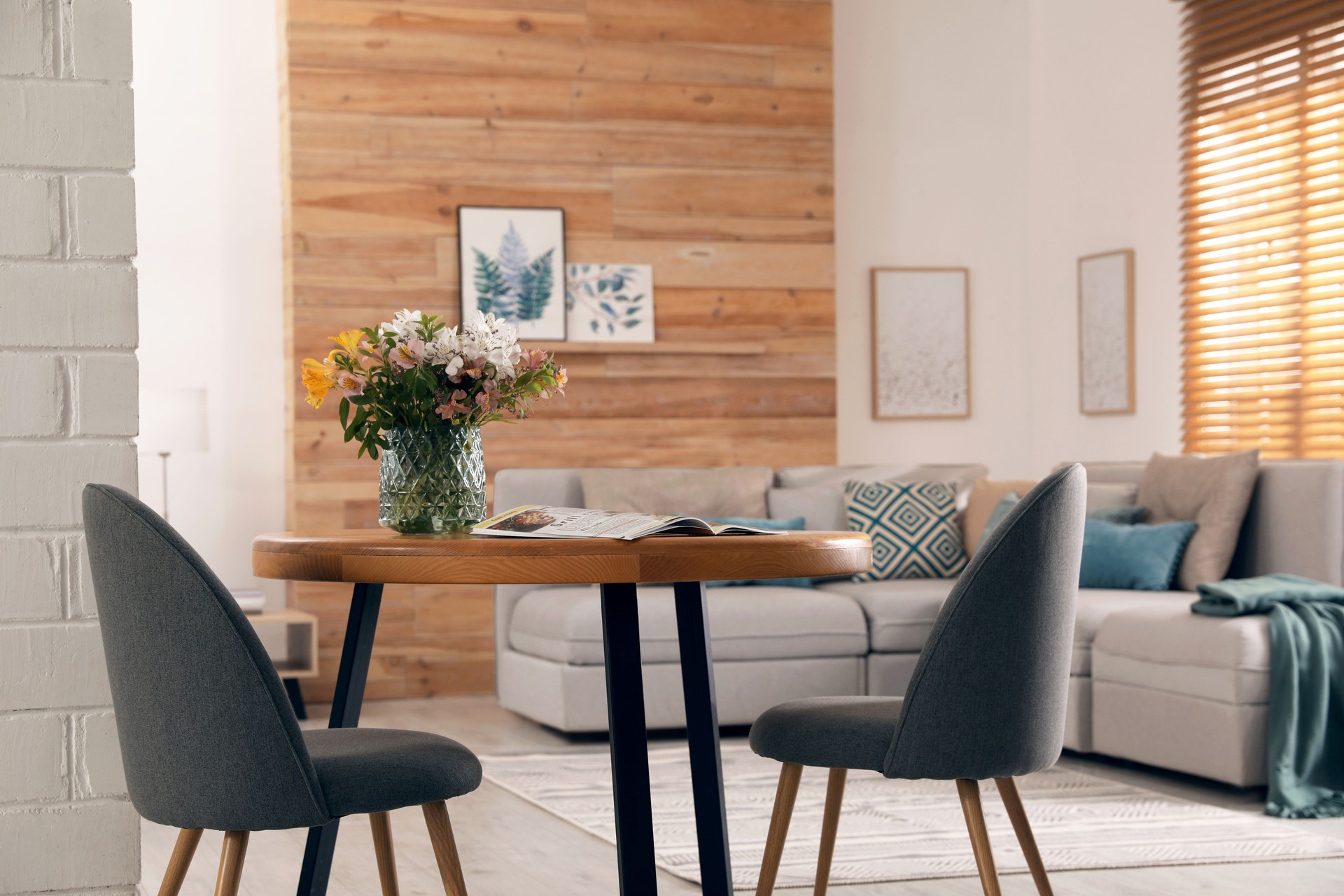 Spacious apartment interior with table and comfortable sofa