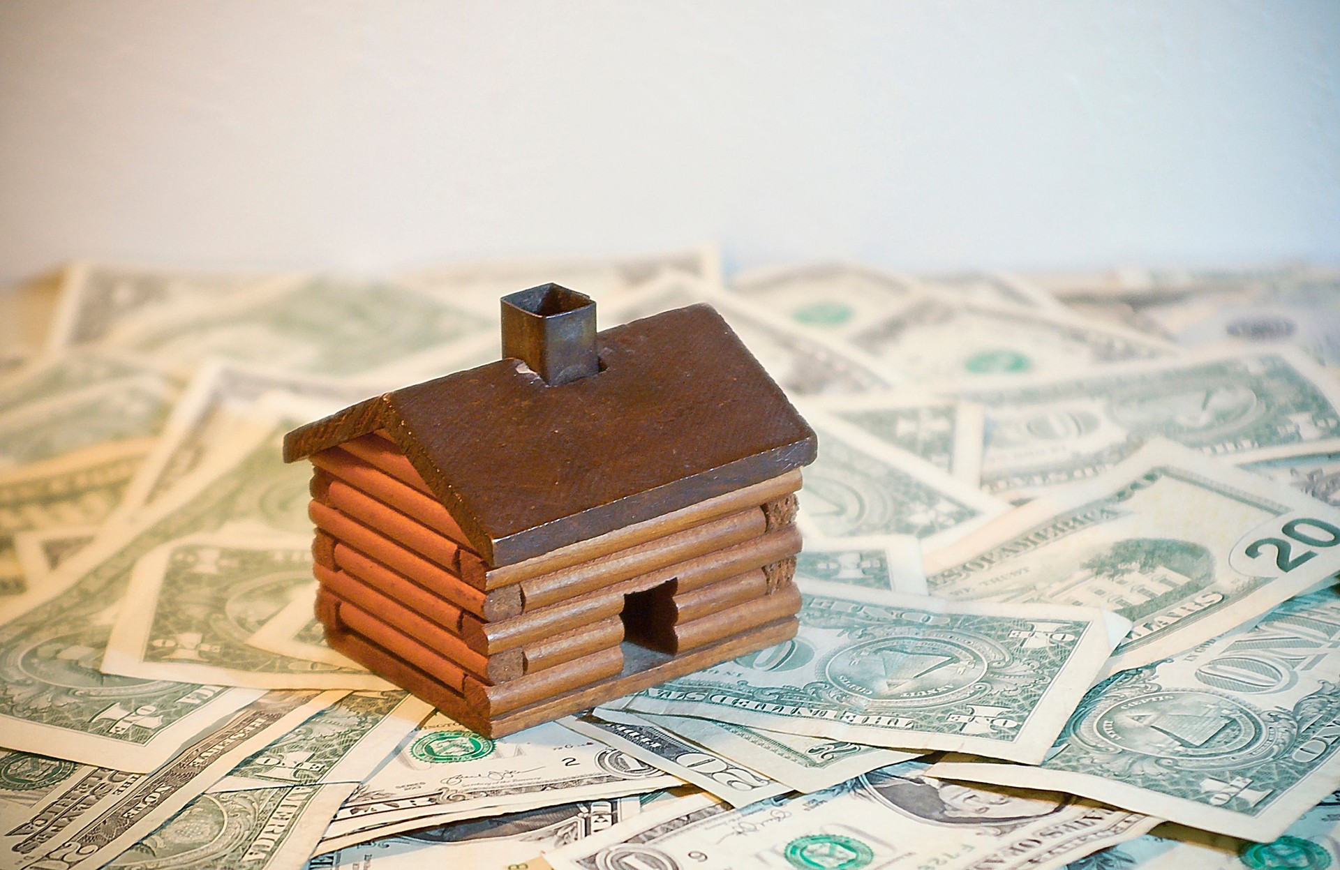 Toy House on Money to Represent Value